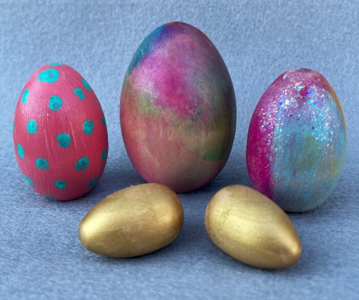 Egg Decorating Kit. A grouping of five wooden eggs, decorated in various colors