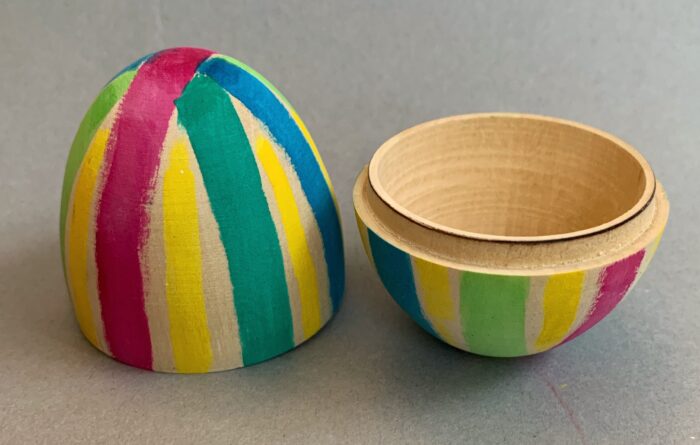 Egg Decorating Kit. Hollow wooden egg in two pieces, painted with watercolor stripes.