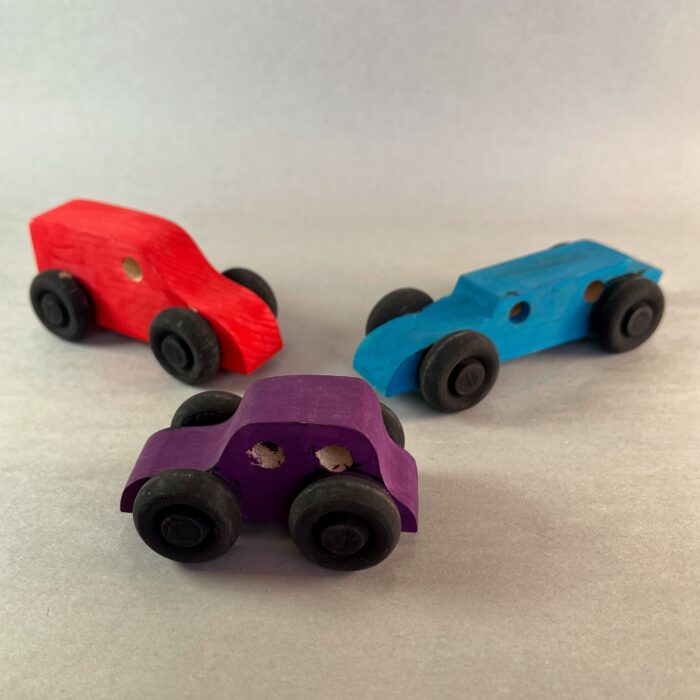 Painted Vehicles Kit. Three small wooden vehicles painted different colors.