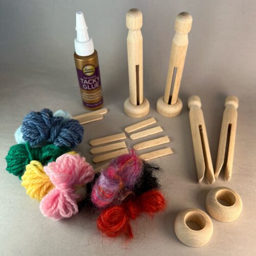 Worry Dolls Craft Kit. Shows the kit contents includinge four clothes pegs, four doll stands, glue, assorted yarn in different colors, and sticks for the dolls' arms.