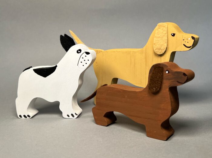 Painted Dogs Kit. Three painted and decorated dogs: a Dachshund, a French Bulldog, and a Labrador Retriever.