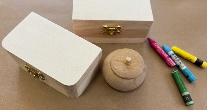 Treasure Boxes Kit. Two rectangular wooden boxes, one small round wood box, and four watercolor crayons