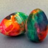 Egg Decorating Kit. Two vibrant wooden eggs that have been decorated using color bleed tissue paper.